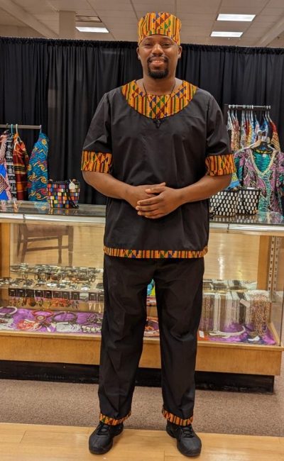 A man standing in front of some jewelry.